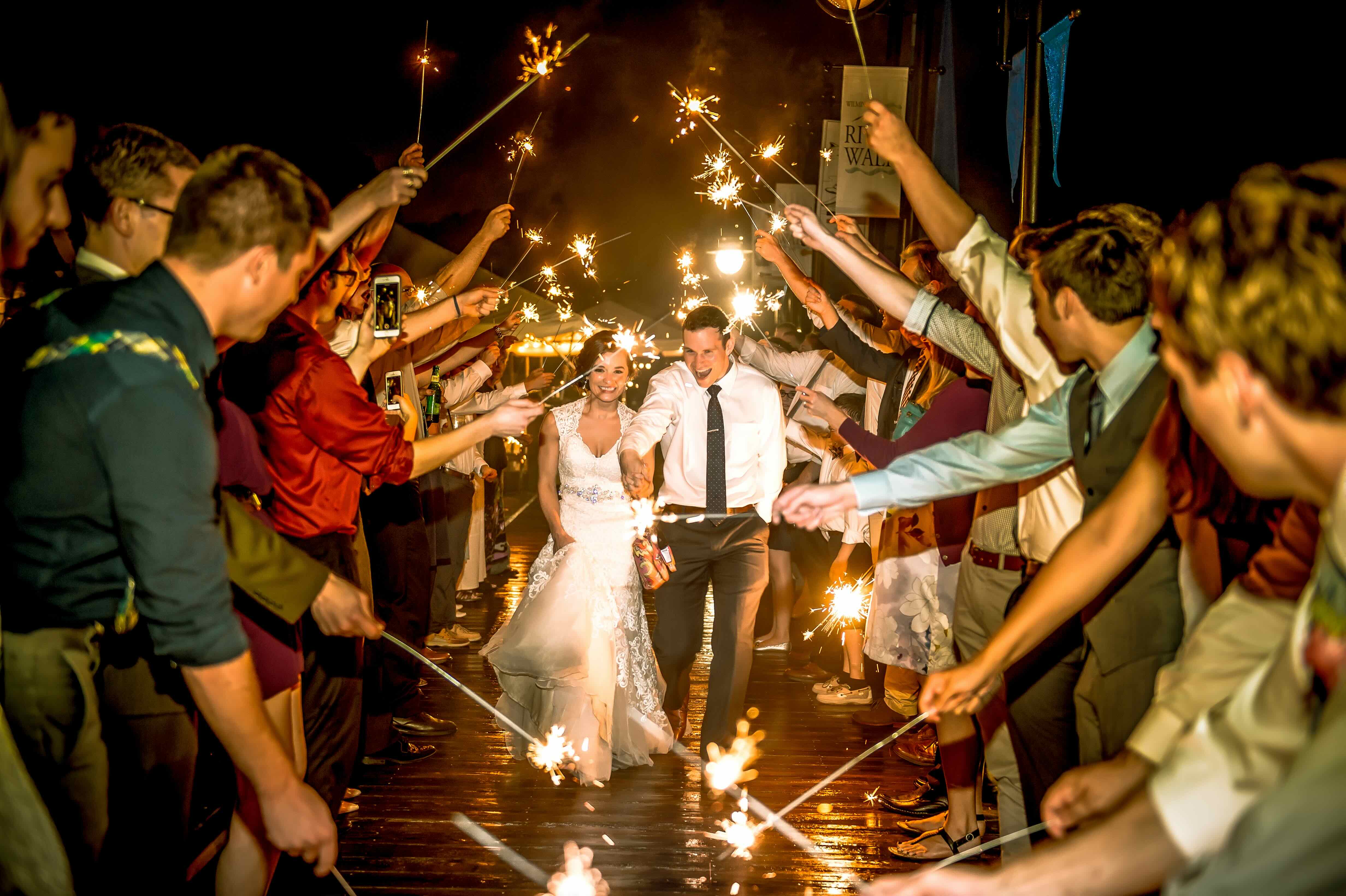 Happy couple celebrating their wedding with sparklers in a magical nighttime moment